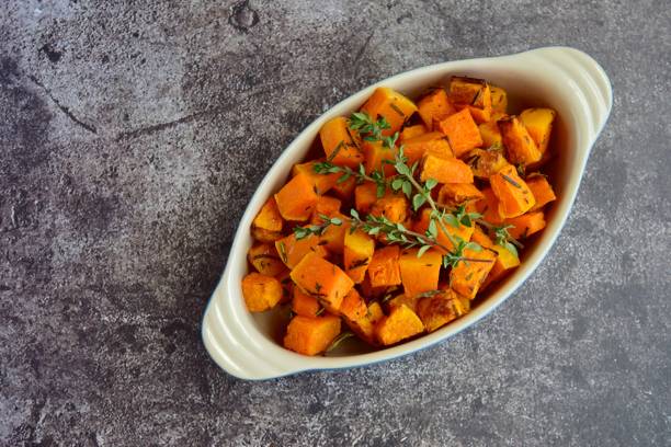 roasted cubed pumpkin with thyme - butternut squash roasted squash cooked imagens e fotografias de stock
