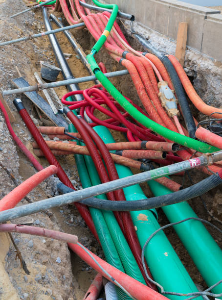 istock road work construction with many colorful tubes and pipes running through an unconvered ditch 1176991153