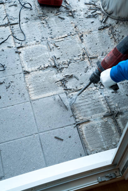 istock construction worker using a handheld demolition hammer and wall breaker to chip away and remove old floor tiles during renovation work 1176992402