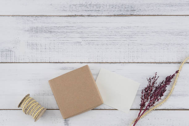 istock Brown gift box, white tiny card, brown rope and violet dried flower 1176993029
