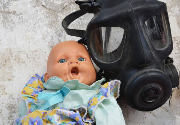 doll and gas mask on the wall