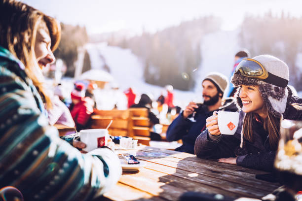 Group of happy friends communicating on a break from skiing in a cafe.