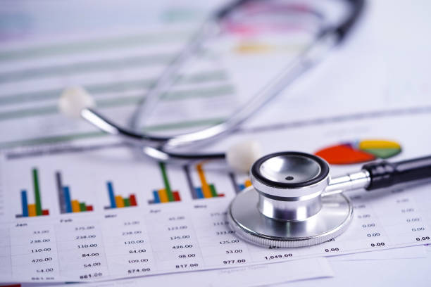 istock Stethoscope, Charts and Graphs spreadsheet paper, Finance, Account, Statistics, Investment, Analytic research data economy spreadsheet and Business company concept. 1176997568