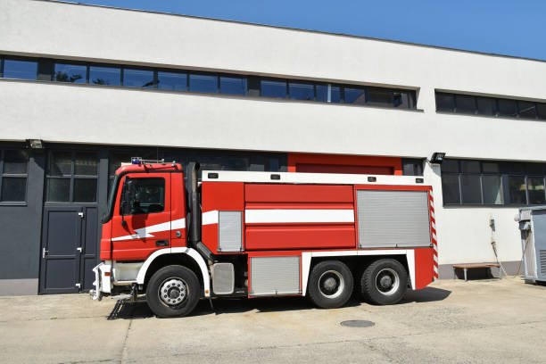 istock Firefighter vehicle next to the fire station 1176998180