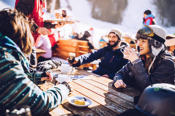 istock Happy skiers talking on a break in a cafe at mountain. 1177000000