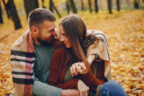 istock Beautiful couple spend time in a autumn park 1177000686