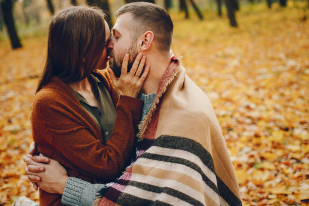 istock Beautiful couple spend time in a autumn park 1177000759