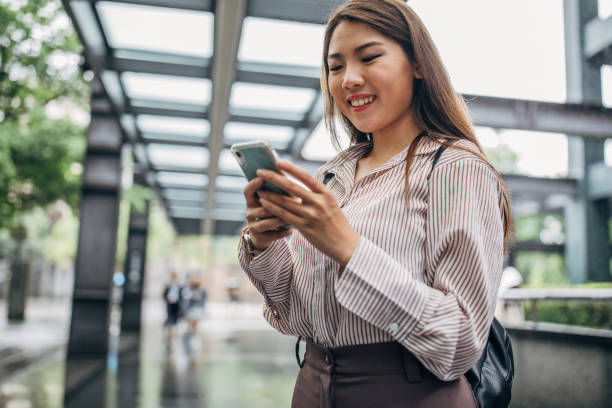 istock Beautiful woman using mobile phone 1177002781