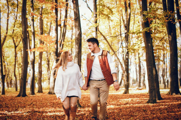 istock Elegant couple in a sunny autumn park 1177004409