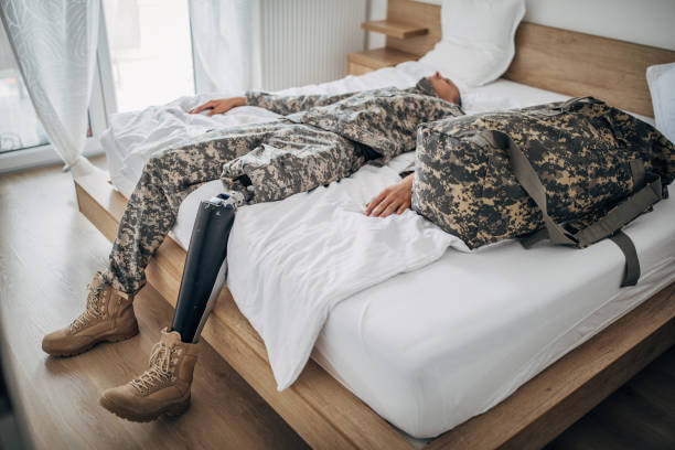 istock Depressed soldier with amputee leg  in the bedroom 1177004536