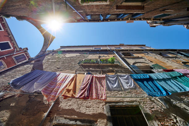 Laundry hanging between buildings in Calle de l'Arco. Sestiere Castello. Veneto. Venice. Italy.