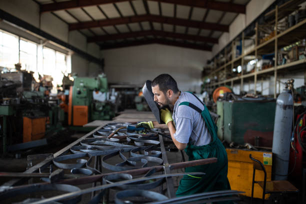istock Young manual worker working hard in production lane 1177008961
