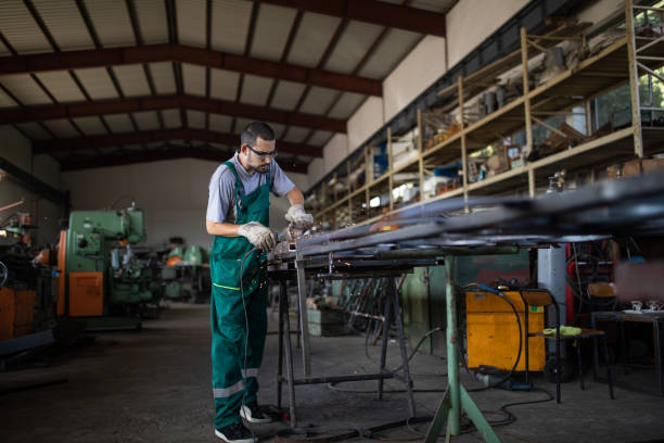 istock Working with angle grinder in metal industry 1177009219