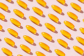 Soft Fish Oil Capsules on Pink Background