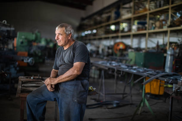 istock Mechanic resting on table in factory 1177010062