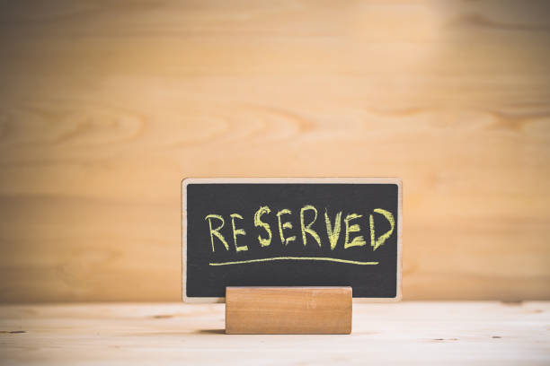 istock reserved text on wooden blackboard on wooden table. 1177010946