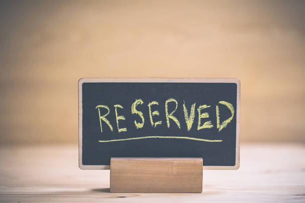 istock reserved text on wooden blackboard on wooden table. 1177011148