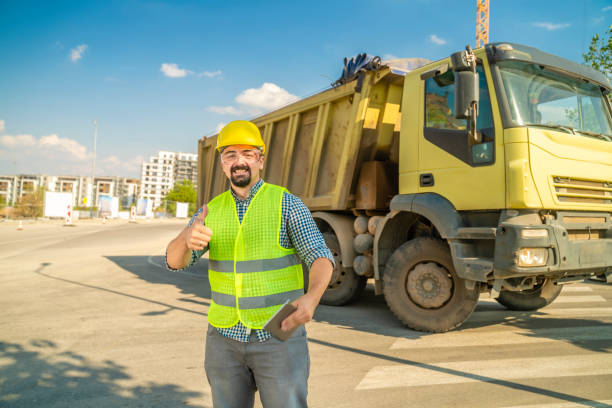 istock Architect or engineer gives thumbs up next to dump truck 1177011590