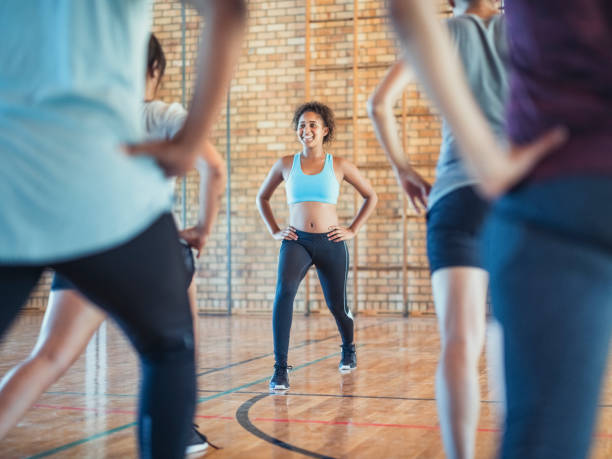 istock Smiling fitness instructor training with athletes 1177012170