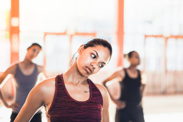 istock Young female athletes exercising with head cocked 1177014076