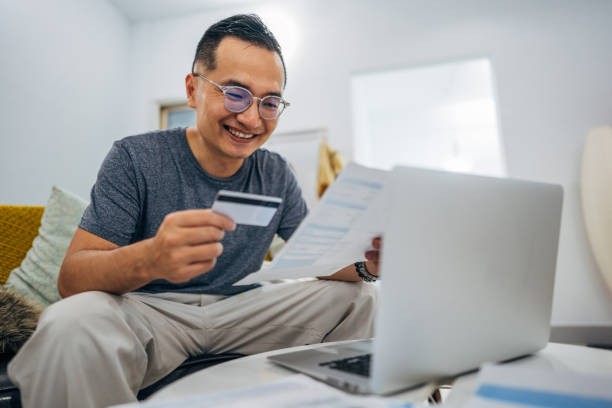 istock Man holding credit card 1177014161