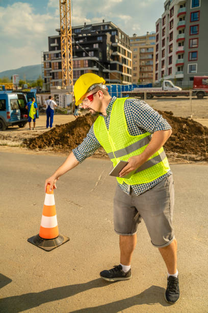 istock Worker placing safety traffic cones at construction site 1177014243