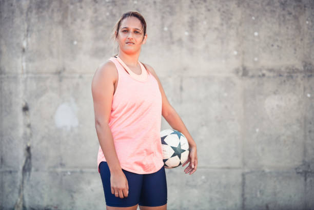 istock Confident soccer player standing against wall 1177015139