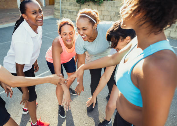 istock Young female players stacking hands before match 1177016261