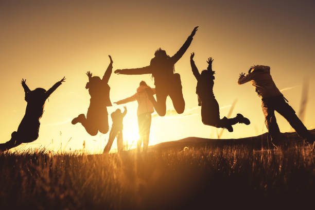 istock Big group of friends jumps and runs at sunset 1177016701