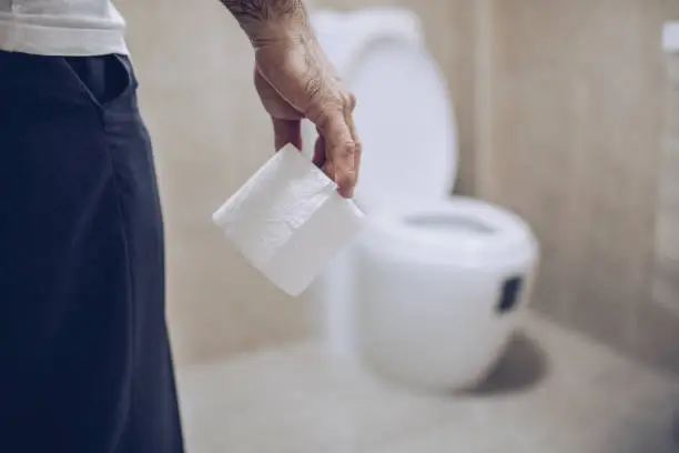 Man suffers from diarrhea holds toilet paper roll