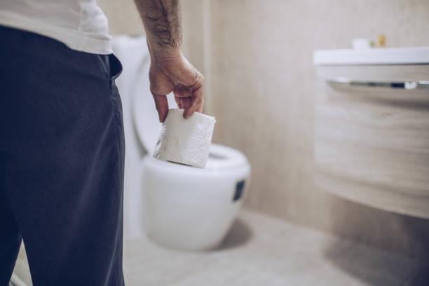 istock Man suffers from diarrhea holds toilet paper roll 1177020086