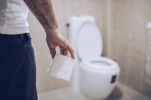 istock Man suffers from diarrhea holds toilet paper roll 1177020105