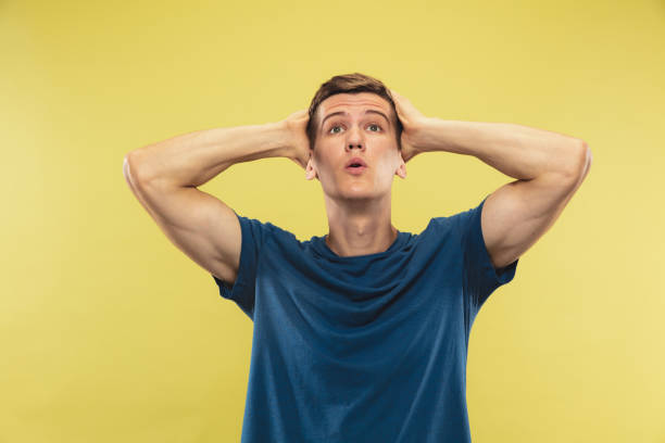 istock Caucasian young man's half-length portrait on yellow background 1177020548