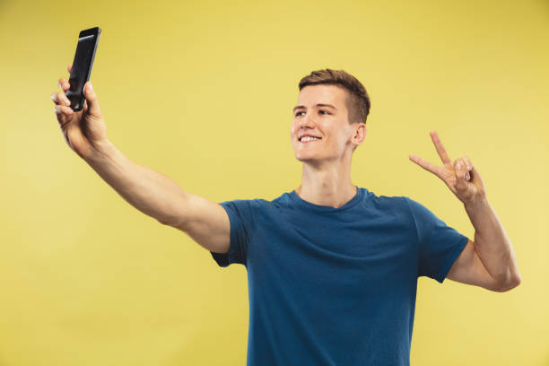 istock Caucasian young man's half-length portrait on yellow background 1177020729