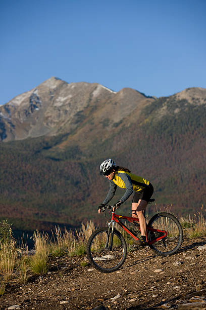 jovem mulher dirigindo moto em montanhas - mountain biking colorado action cycling imagens e fotografias de stock