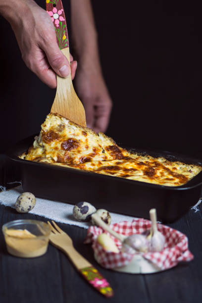 istock hand cook lasagna with meat and cheese, with sauce 1177023134
