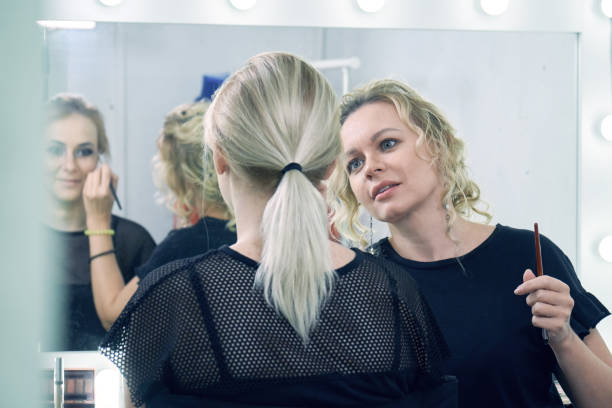 istock Make-up artist making a make-up for a young model before a photo session 1177023348