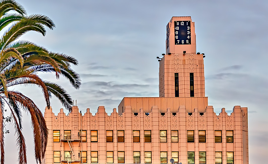 View of top of landmark clock tower building in Santa Monica, California, with sunset light.