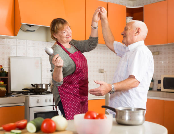 istock Senior man and woman dancing in kitchen 1177024356