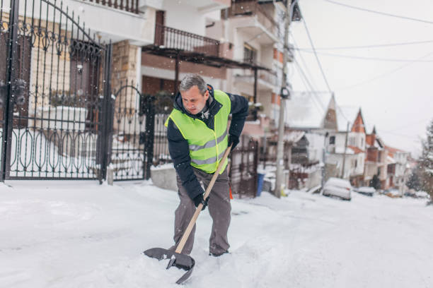 istock Senior man cleaning snowy doorway 1177024788