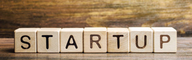 istock Wooden blocks with the word Startup. Temporary structure designed to find and implement a scalable business model. The concept of raising funds for a startup. Crowdfunding. Investing in the future. 1177027690