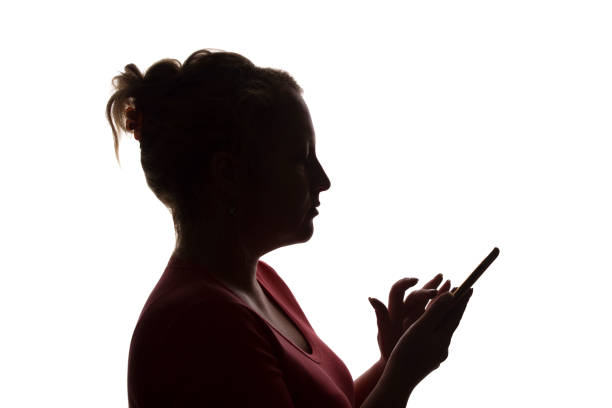 istock Silhouette girl with a mobile smart phone, using - isolated, technology 1177027876