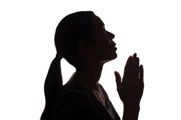 istock Young woman looking up with hope and request - silhouette 1177028141