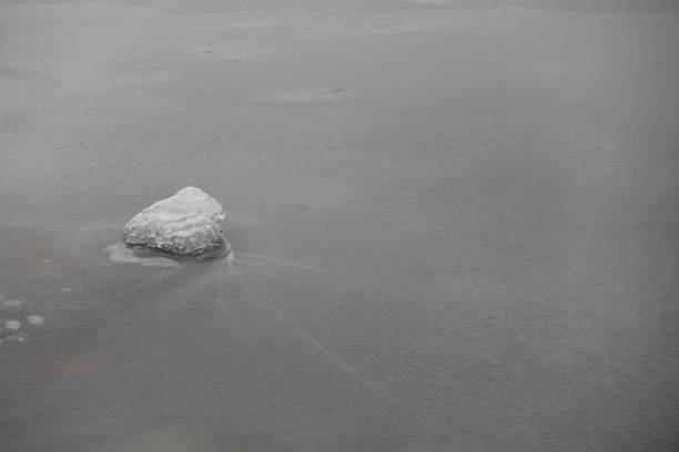 istock Frozen lake with small rock 1177028180