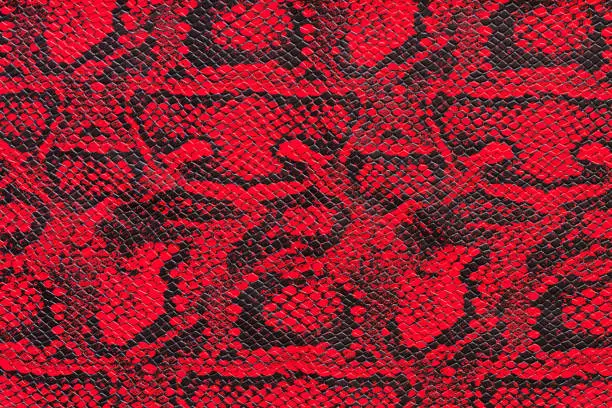 Texture of synthetic red snake skin for various purposes.