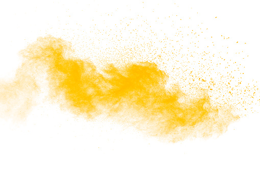 Abstract yellow  powder explosion on white background. Freeze motion of yellow  dust particles splash.