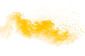Abstract yellow powder explosion on white background. Freeze motion of yellow  dust particles splash.
