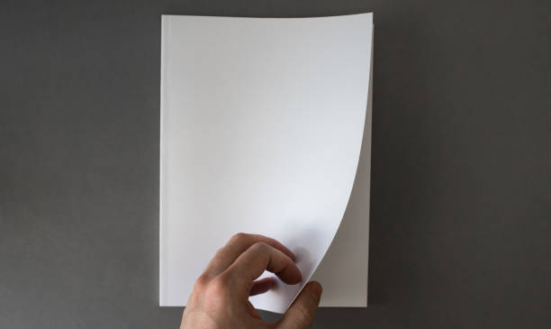 Hand opening blank white brochure with copy space stock photo