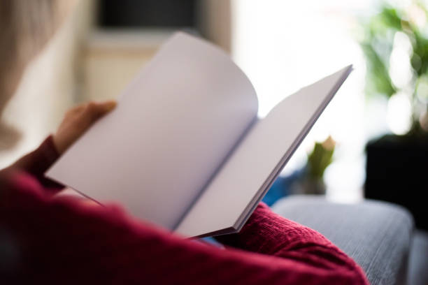 istock Woman looking at white blank brochure with copy space 1177030044