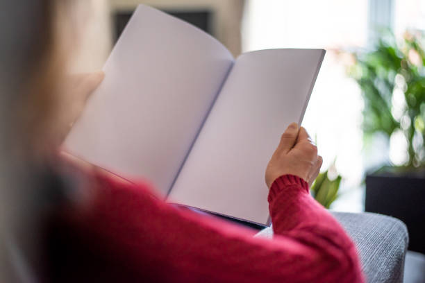 looking at a blank brochure with copy space - newspaper reading blank women imagens e fotografias de stock